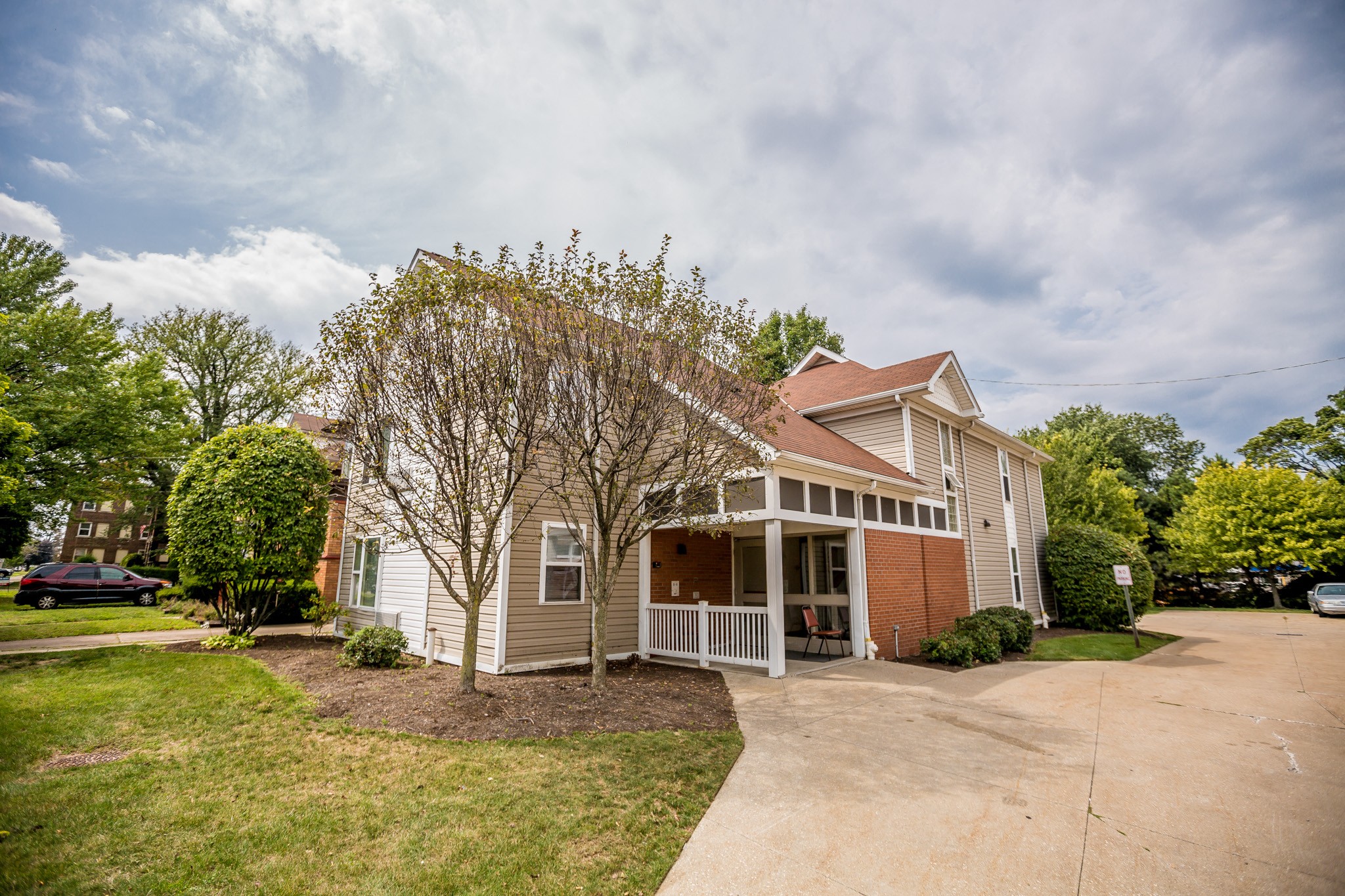 the front of a house with a porch and a driveway